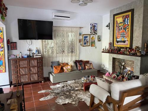 a living room with a couch and a fireplace at Mini casa en el mirador San Bernardino. Guarania in San Bernardino