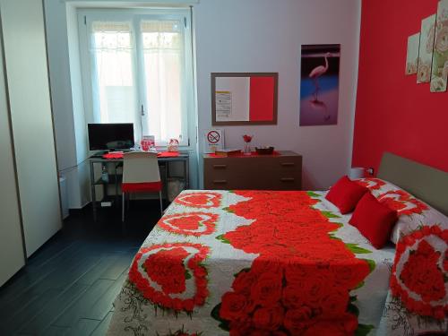 a bedroom with a bed with a red wall at Affittacamere Sa Pardula in Cagliari