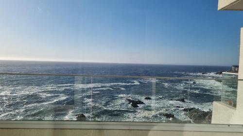 a view of the ocean from a window at Exclusivo Departamento Con Con Primera Linea in Concón