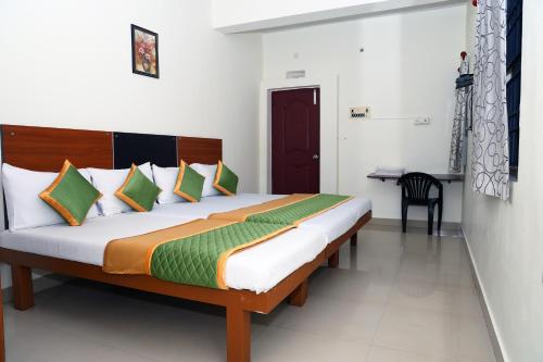 a bedroom with a large bed in a room at Royal Green - Airport Stay in Chennai