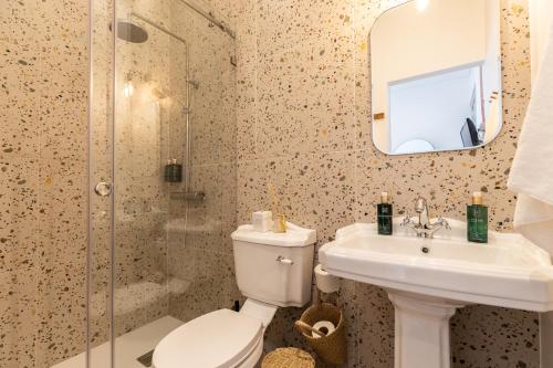 a bathroom with a toilet and a sink and a shower at Amália Boutique Suites & Studios - by @ rita´s place in Faro