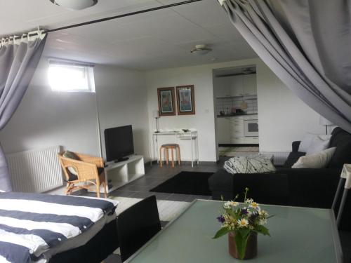 a living room with a bed and a couch at Lägenhet Lillisgården in Vallåkra