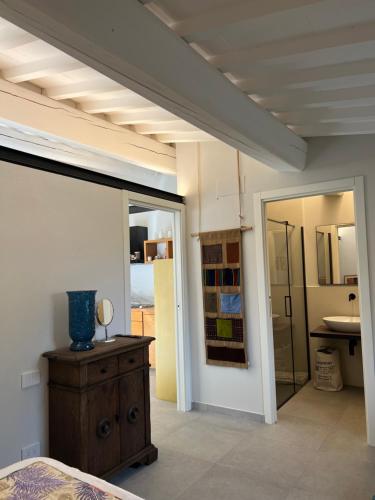 a bedroom with a bed and a bathroom with a mirror at Joy home in Antella