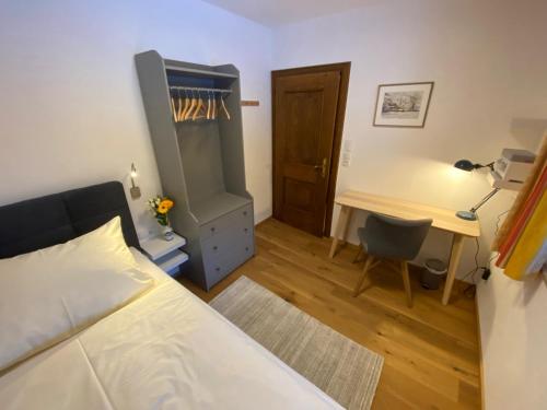 a bedroom with a bed and a desk and a desk at Oberleiten Apartments in Wagrain