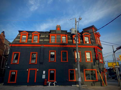 a large building with red windows on a street at Royal Oak Inn in Toronto