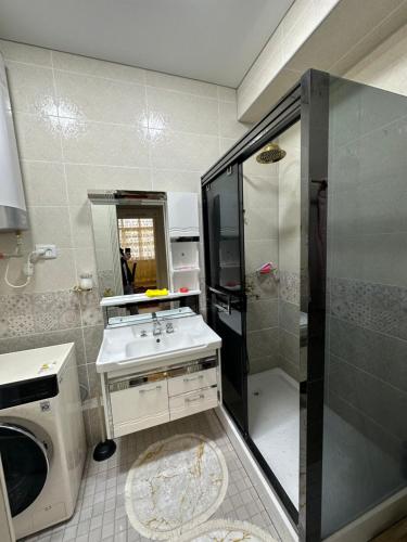 a small bathroom with a sink and a shower at Apartment Vefa Center in Dushanbe