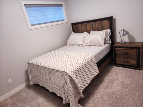 1 dormitorio con cama y ventana en Deluxe 2 bedroom suite with*Netflix/Cable/Prime en Edmonton