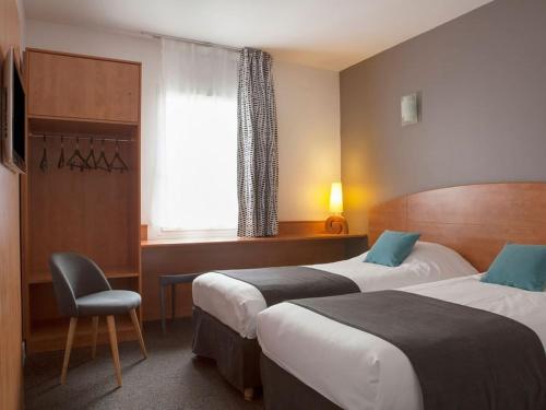 a hotel room with two beds and a chair at The Originals City, Plume Hôtel, Bressuire (Inter-Hotel) in Bressuire
