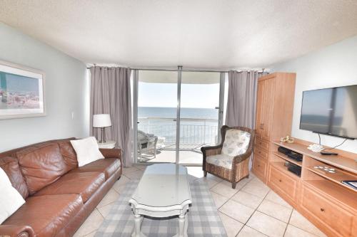 a living room with a couch and a television at 0611 Waters Edge Resort condo in Myrtle Beach
