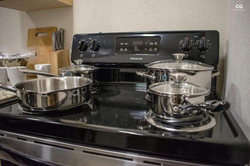 two pots and pans on a stove in a kitchen at Cozy Studio with free parking on premises. in Grand Anse