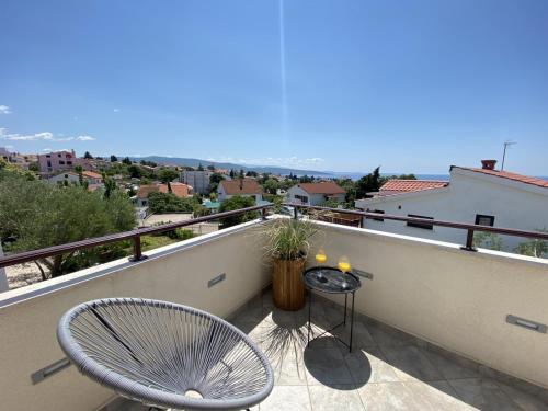 a balcony with two chairs and a table and a view at Charming Villa Ira with Pool in Krk