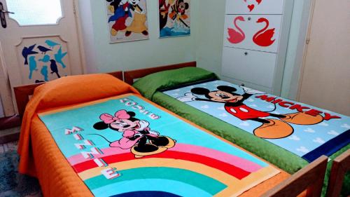 two beds with hello kitty towels on them in a bedroom at The Secret Garden Maratea - Casa di Sery in Maratea