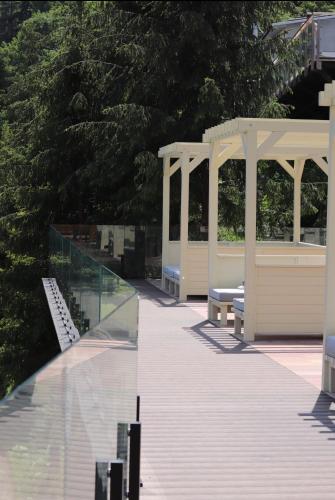 a boardwalk with benches and a gazebo at MORVA Premium Spa Resort in Yaremche