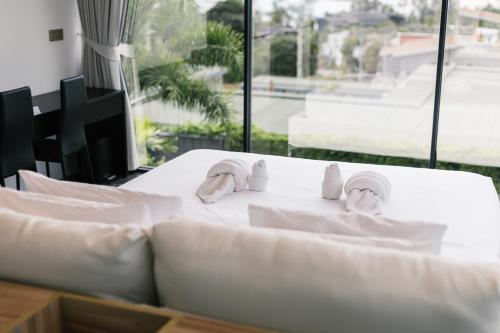 a table with towels and masks on top of it at Villa Obsidian, with staff, sea view and walk to Choeng Mon beach in Choeng Mon Beach