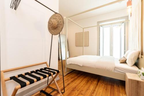 a bedroom with a bed and a swing at Amália Boutique Suites & Studios - by @ rita´s place in Faro