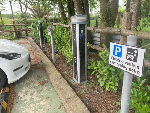 a parking meter with a parking sign next to a car at The Bickford Arms Inn in Holsworthy