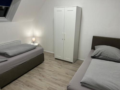 En eller flere senge i et værelse på Wohnen wie zu Hause