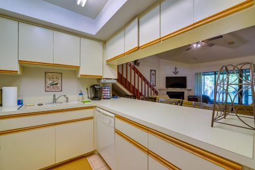 a large kitchen with white cabinets and a sink at Waterfront Dunnellon Retreat with River Access! in Dunnellon