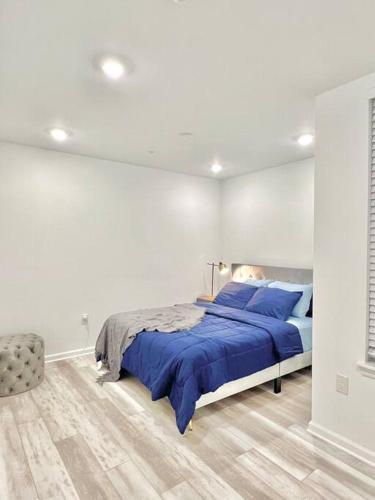 a white bedroom with a bed with blue pillows at Extravagant 3 Bedroom Near art Museum in Philadelphia