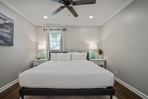 a bedroom with a white bed and a ceiling fan at Rustic 3BR Home in a Natural Cartersville Getaway in Cartersville
