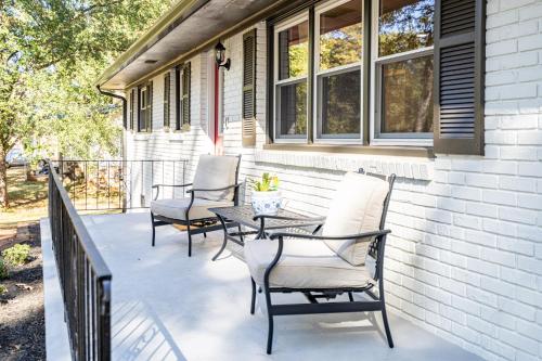 a patio with chairs and a table on a house at Rustic 3BR Home in a Natural Cartersville Getaway in Cartersville