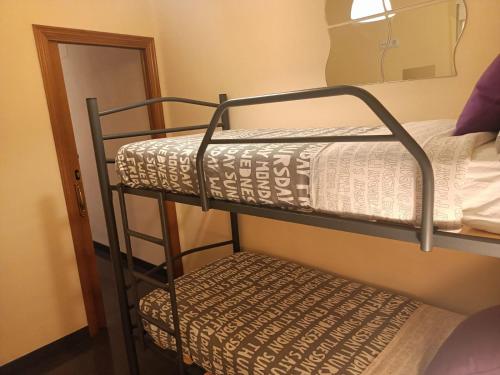 a couple of bunk beds in a room at Habitaciones Centricas en una casa Valenciana in Valencia
