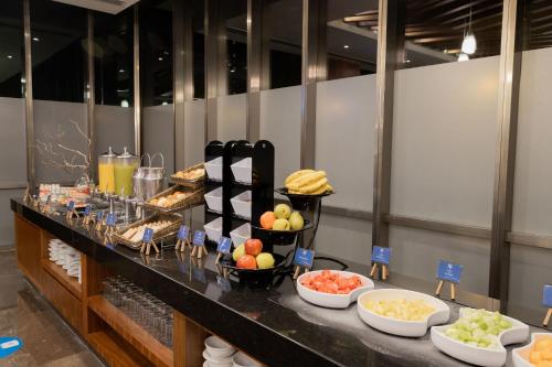 a buffet with different types of food on a table at Camino Real Fashion Drive Monterrey in Monterrey