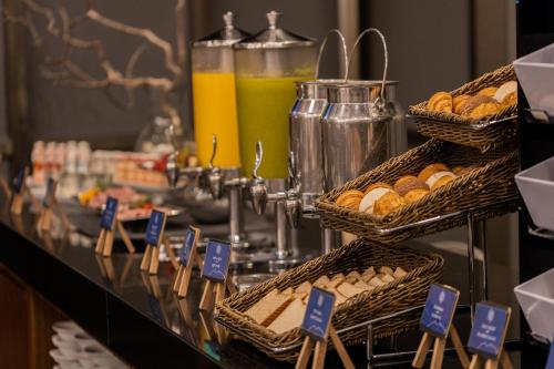 a buffet line with baskets of pastries and drinks at Camino Real Fashion Drive Monterrey in Monterrey