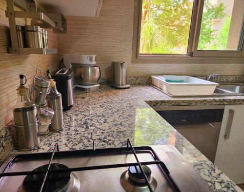 a kitchen with a stove and a counter top at Prestigia marrakech in Marrakesh