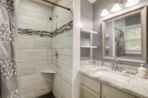 a bathroom with a shower and a sink and a mirror at Quiet Decatur Home with Patio 13 Mi to Dtwn Atlanta! in Decatur