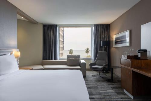 a hotel room with a bed and a large window at Radisson Blu Okoume Palace Hotel, Libreville in Libreville