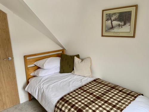 a bedroom with a bed with a checkered blanket at Stunning Apartment in Callander in Callander