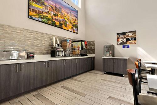 a waiting room at a restaurant with a counter at SureStay Plus Hotel by Best Western Tulsa East in Tulsa