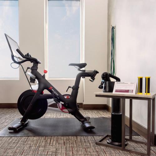 a room with a exercise bike next to a table at H Hotel Los Angeles, Curio Collection By Hilton in Los Angeles