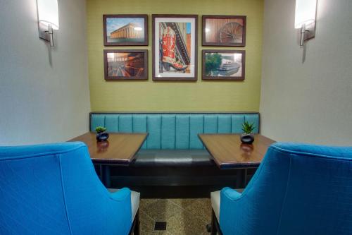 a restaurant with two tables and a blue bench at Drury Inn & Suites Nashville Airport in Nashville