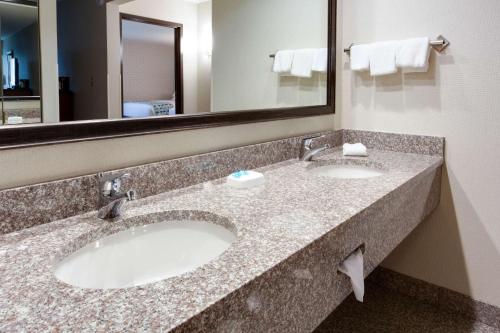 a hotel bathroom with two sinks and a large mirror at Drury Inn & Suites Nashville Airport in Nashville