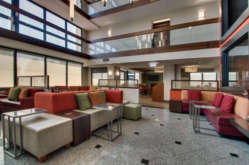 a lobby with couches and tables and windows at Drury Inn & Suites Evansville East in Evansville