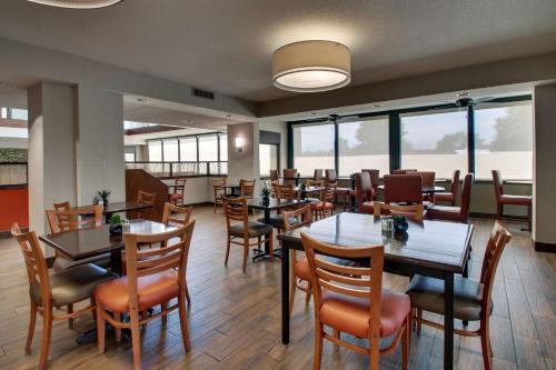 a dining room with tables and chairs and windows at Drury Inn & Suites Evansville East in Evansville