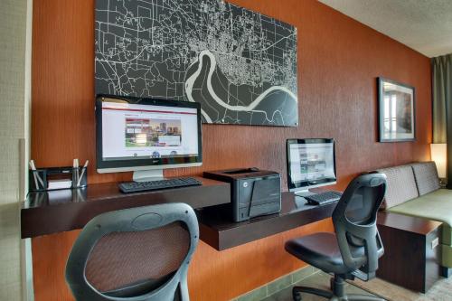 an office with a desk with a computer and a chair at Drury Inn & Suites Evansville East in Evansville