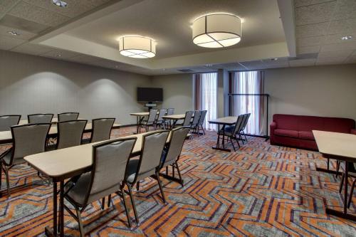 a conference room with tables and chairs and a couch at Drury Inn & Suites Evansville East in Evansville