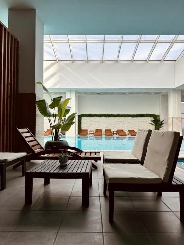 a living room with a couch and a swimming pool at Royal Kate Apartments Spa included 30th floor in Skopje