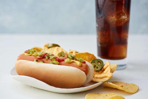 a plate with a hot dog and chips at Drury Inn & Suites Huntsville Space & Rocket Center in Huntsville