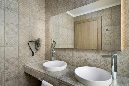 a bathroom with a sink and a mirror at Radisson Blu Resort Al Hoceima in Al Hoceïma