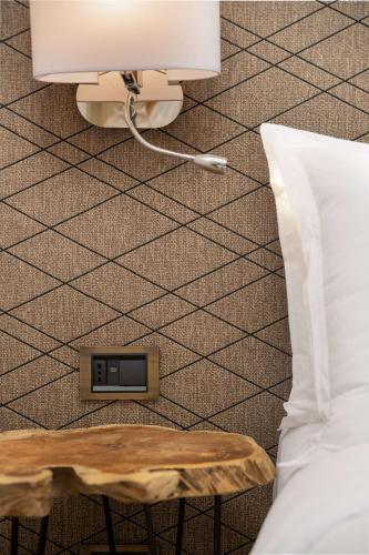 a bedroom with a bed and a table with a lamp at Radisson Blu Resort Al Hoceima in Al Hoceïma