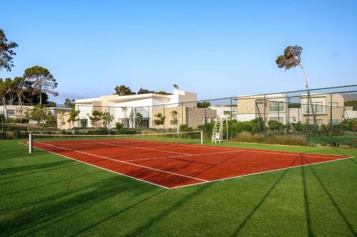 a tennis court in front of a building at Radisson Blu Resort Al Hoceima in Al Hoceïma