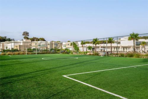 an empty tennis court in front of a building at Radisson Blu Resort Al Hoceima in Al Hoceïma