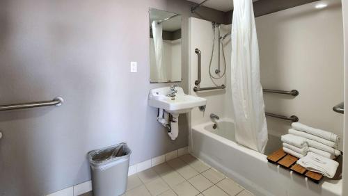 a bathroom with a sink and a shower and a tub at Studio 6 Webster TX Houston NASA Lake in Webster