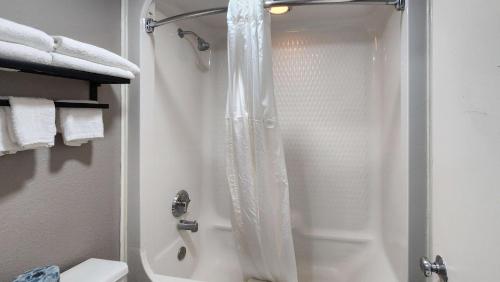 a shower with a shower curtain in a bathroom at Studio 6 Webster TX Houston NASA Lake in Webster