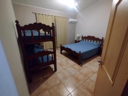 a bedroom with two bunk beds and a doorway at La Pocilga in Paso de la Patria