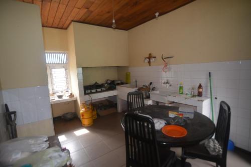 a kitchen with a table and chairs in a room at Browns Peak in Matara